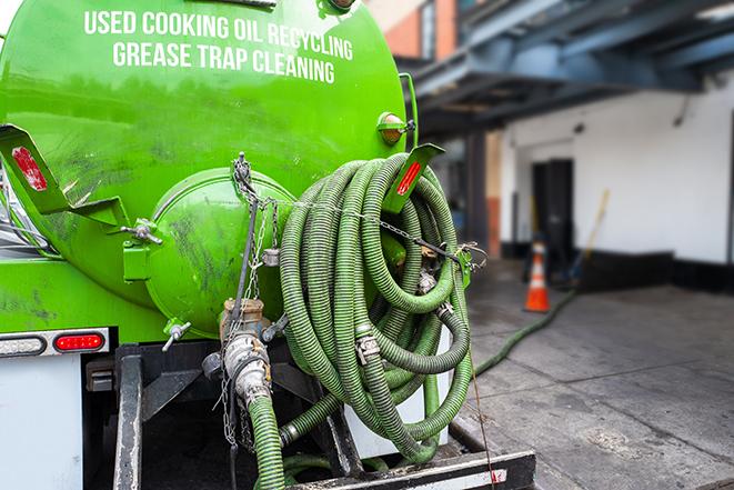 a grease trap being pumped by a sanitation technician in Cherry Hill, NJ